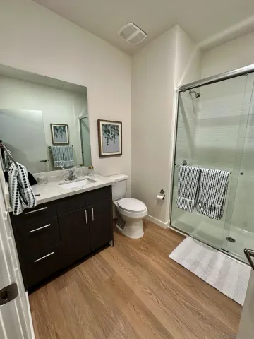 a spacious bathroom with a double vanity sink and a mirror