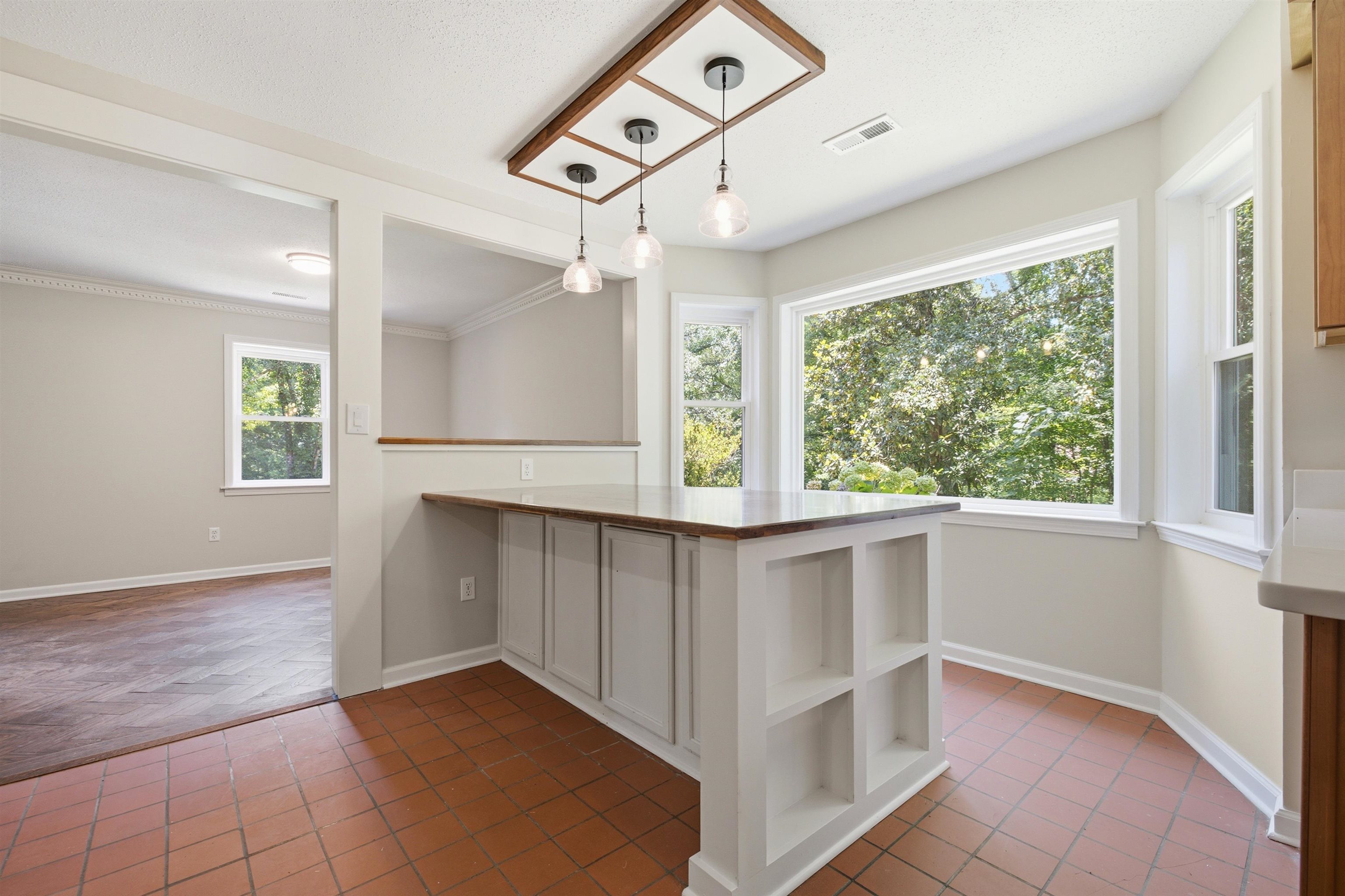 1370 North Reid Hooker Road Eads, TN 38028 - Photo 21 of 39 Kitchen island with built-in shelving, wood-finish countertop, and pendant lighting