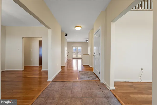 a view of a livingroom with wooden floor and a ceiling fan