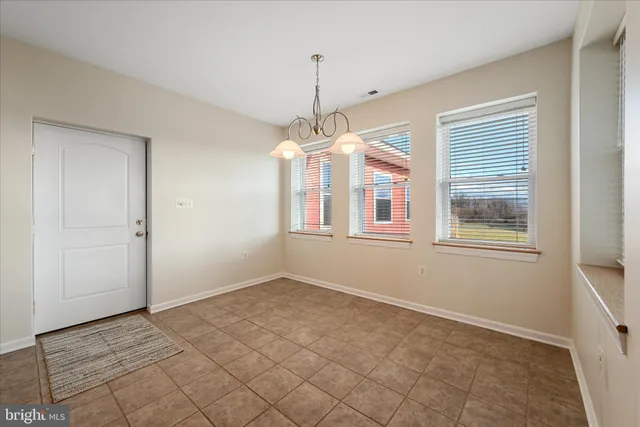 a view of an empty room and wooden floor