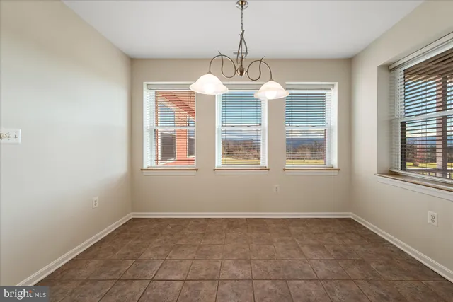 an empty room with wooden floor cabinet and door