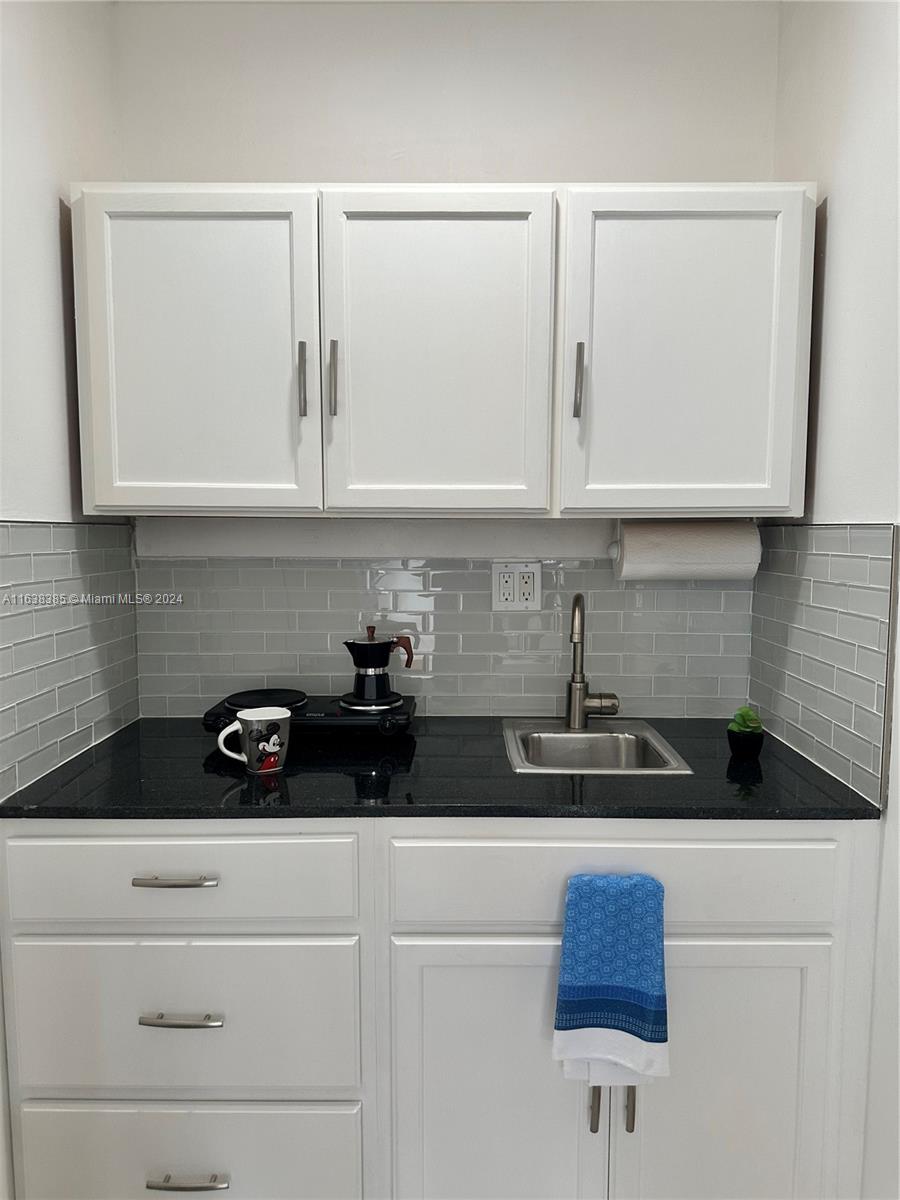 15501 Southwest 143rd Avenue, Unit 15501 Miami, FL 33177 - Photo 11 of 11 a kitchen with a sink and cabinets