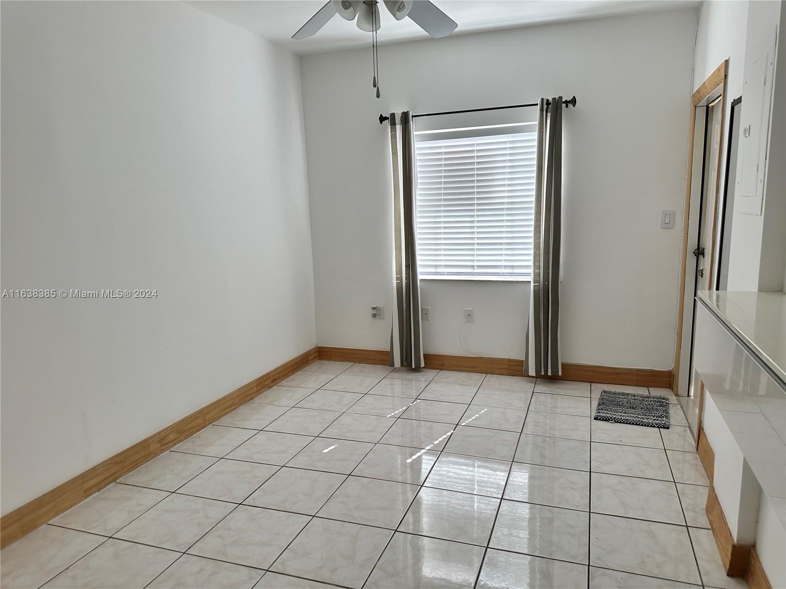 15501 Southwest 143rd Avenue, Unit 15501 Miami, FL 33177 - Photo 4 of 11 a view of an empty room with a window