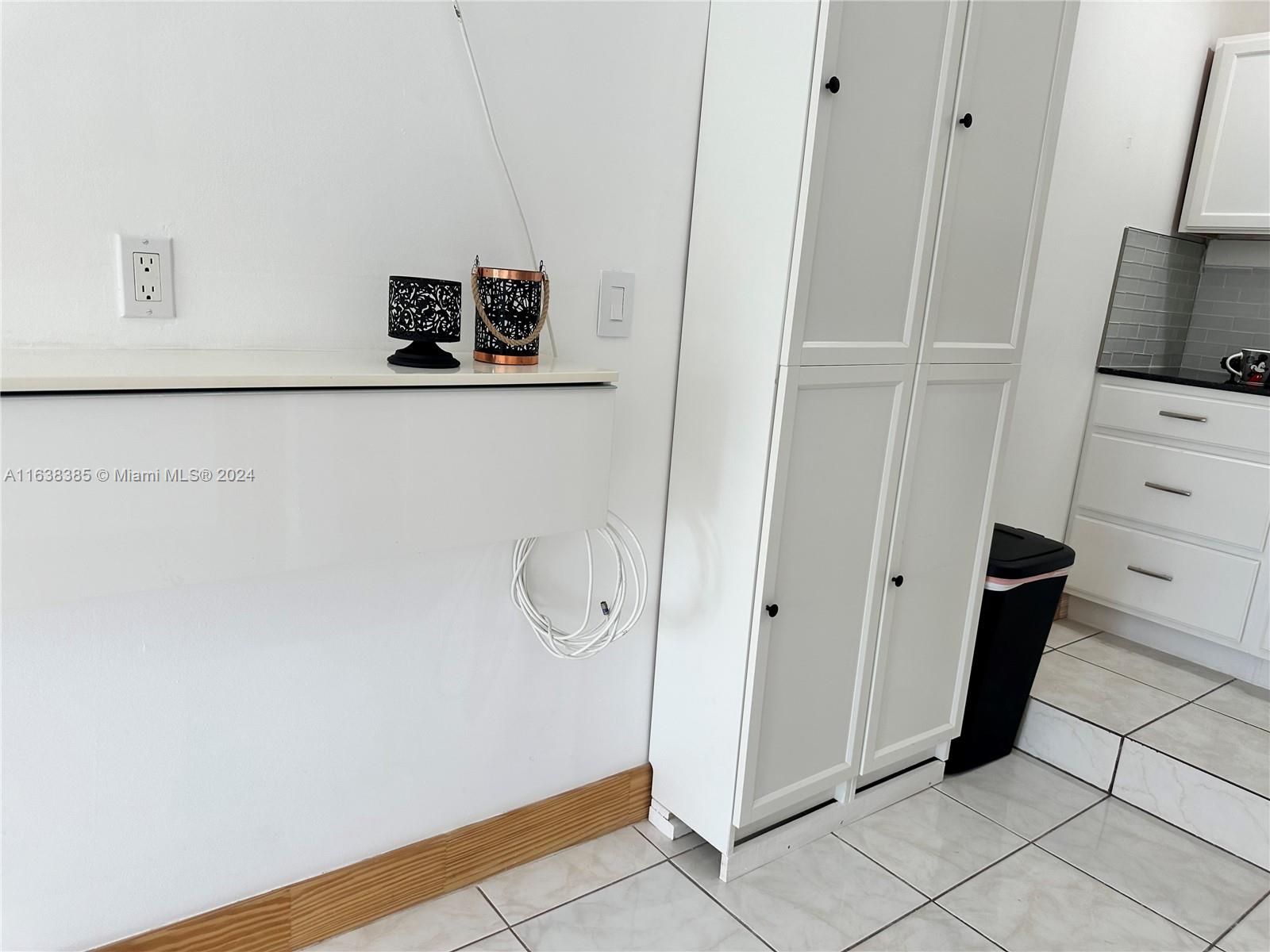 15501 Southwest 143rd Avenue, Unit 15501 Miami, FL 33177 - Photo 5 of 11 a view of a refrigerator and an empty room