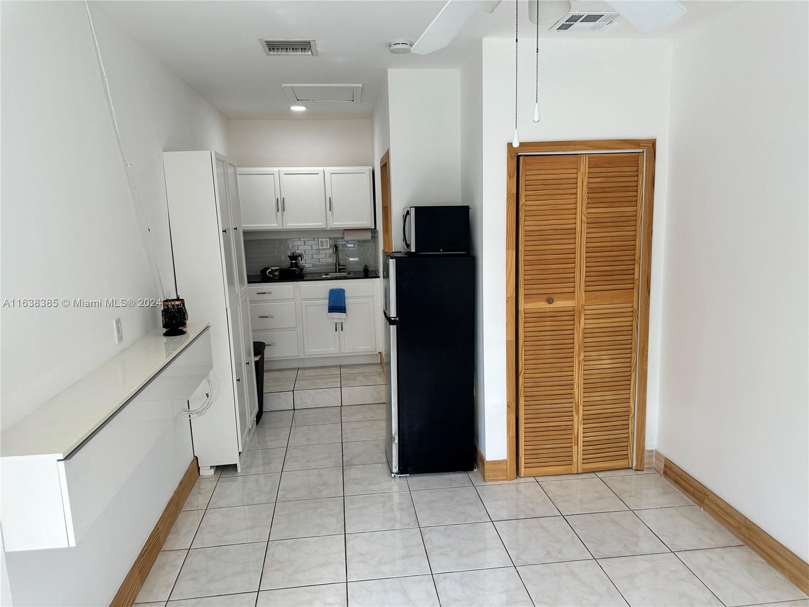 15501 Southwest 143rd Avenue, Unit 15501 Miami, FL 33177 - Photo 6 of 11 a bathroom with a sink a toilet and shower