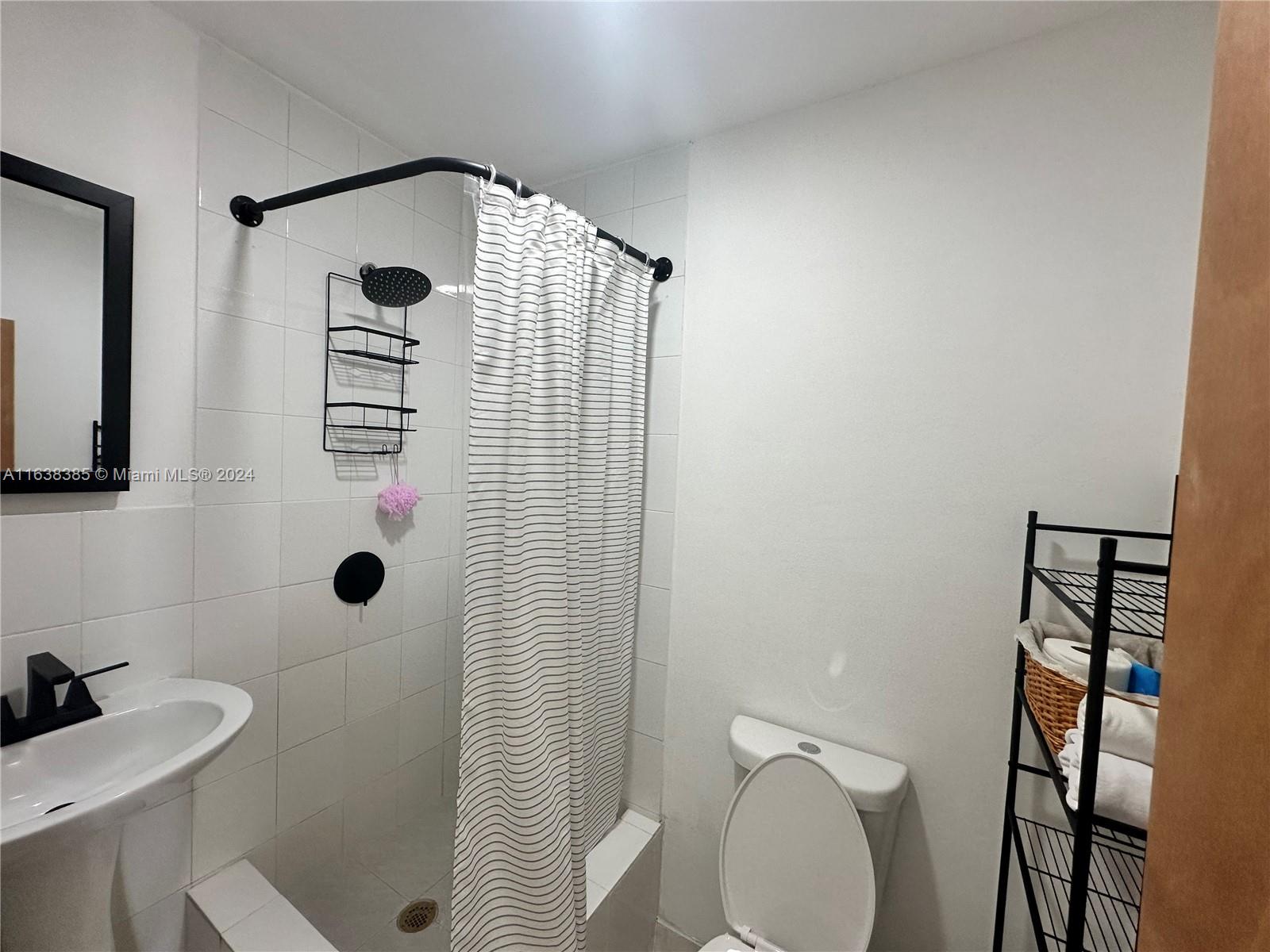 15501 Southwest 143rd Avenue, Unit 15501 Miami, FL 33177 - Photo 9 of 11 a bathroom with a sink toilet and shower