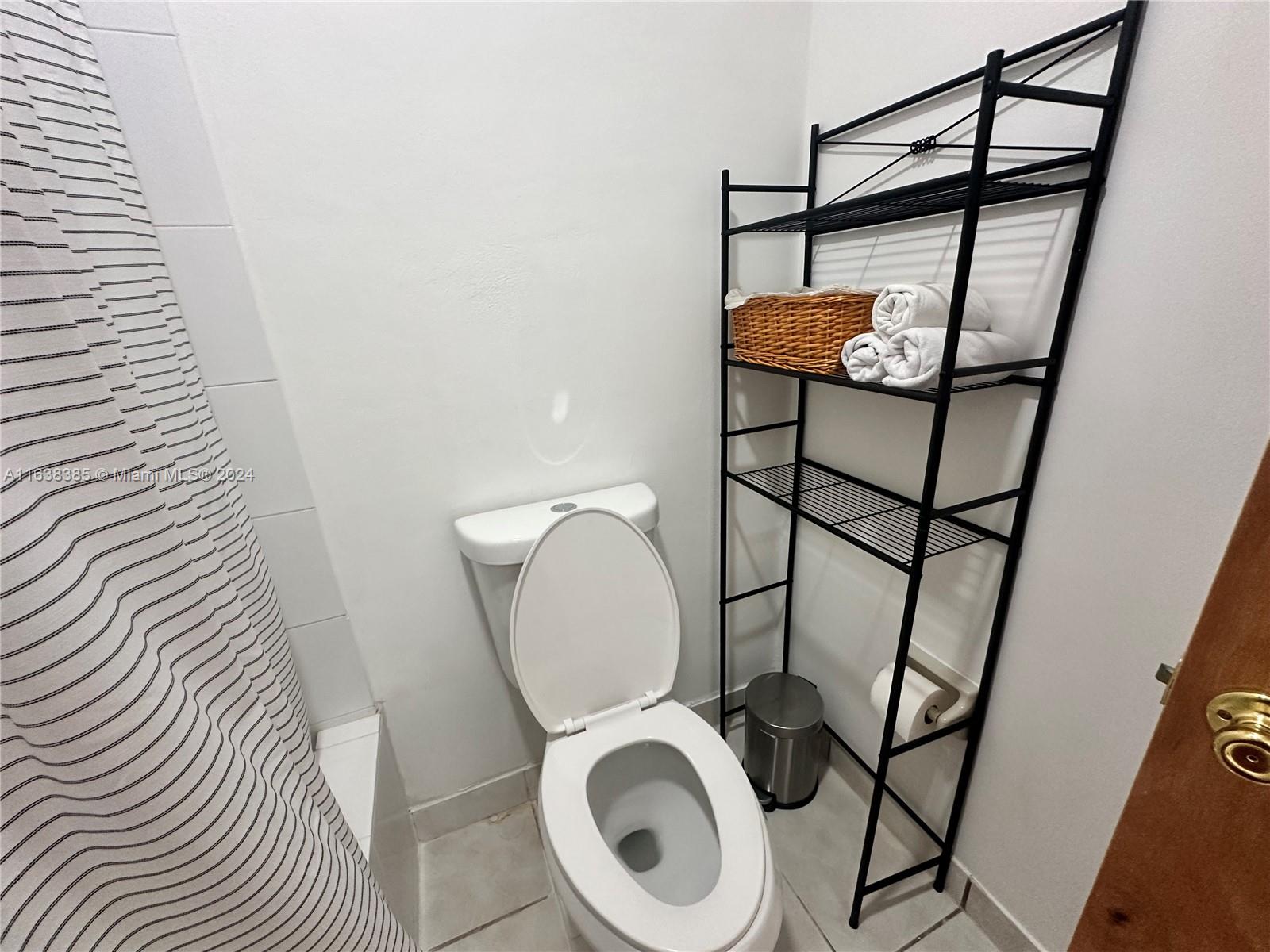 15501 Southwest 143rd Avenue, Unit 15501 Miami, FL 33177 - Photo 10 of 11 a bathroom with a toilet and a sink
