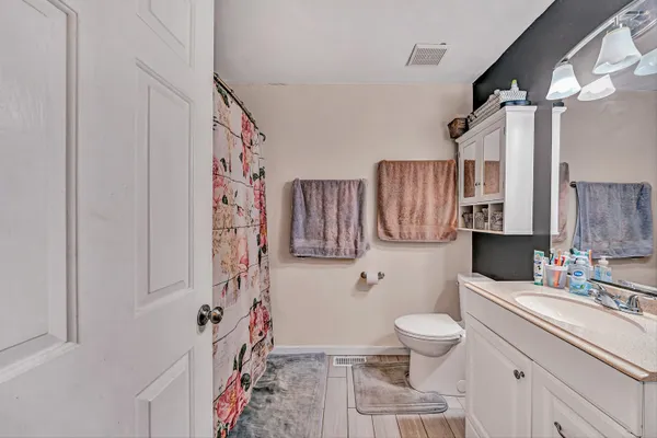 a bathroom with a sink toilet and shower