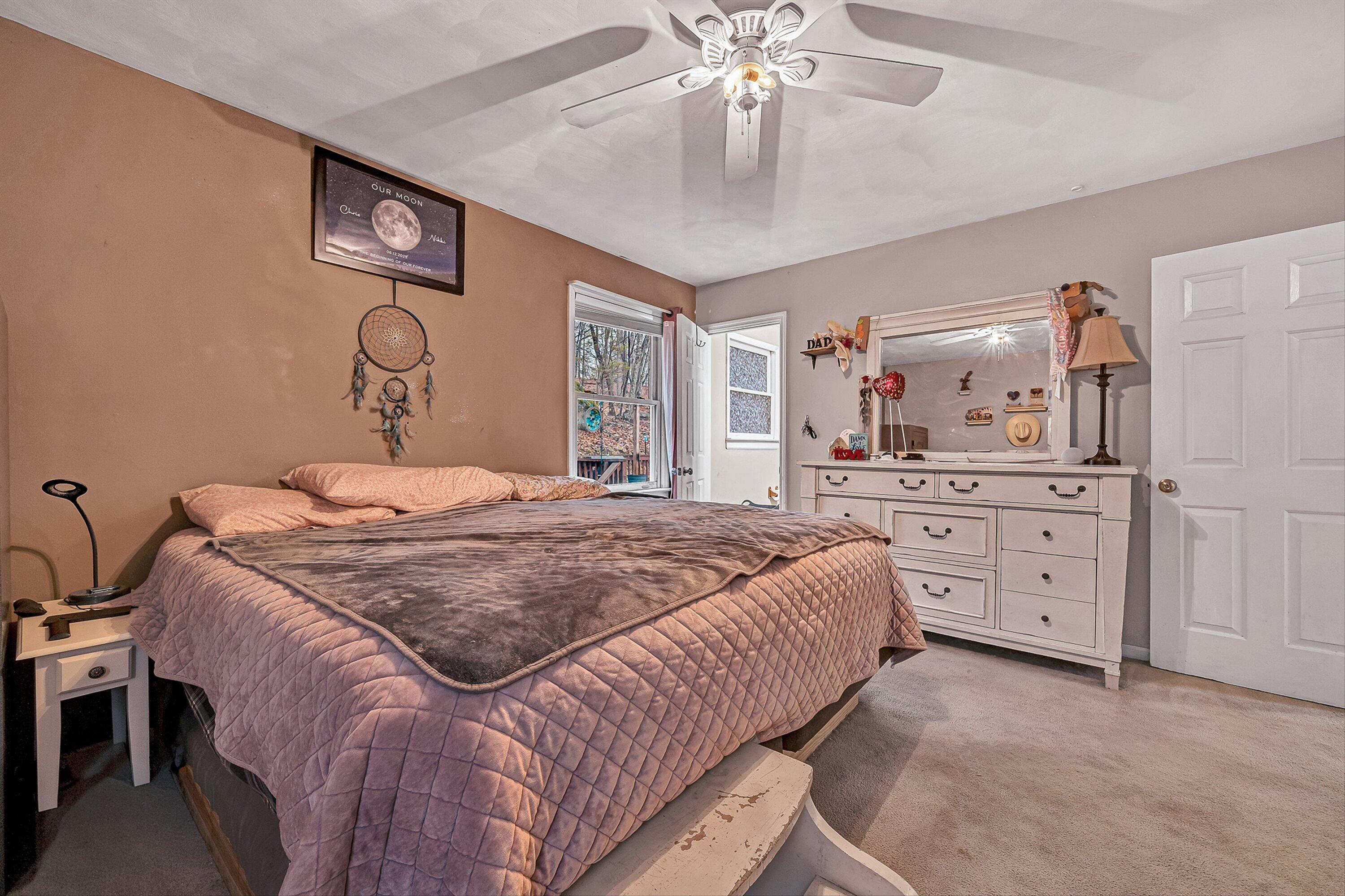 769 Lakeshore Terrace Road Hardy, VA 24101 - Photo 15 of 38 a bedroom with a large bed and a chandelier