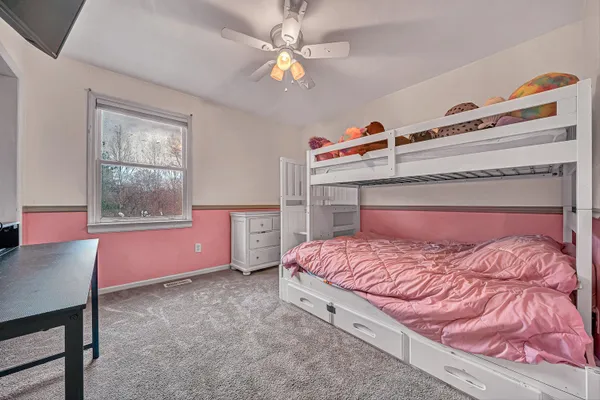 a bedroom with a bed and a table with lamp