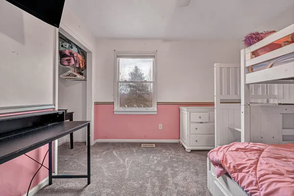 a bedroom with a bed and a window