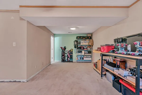 a view of an empty room with fridge and closet