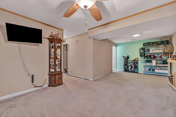 a view of a livingroom with furniture and a ceiling fan