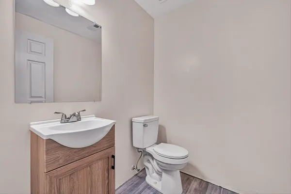 a bathroom with a sink toilet and vanity