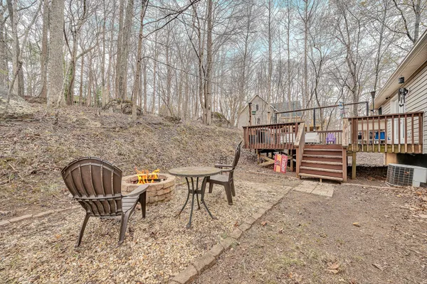 a backyard of a house with barbeque oven table and chairs