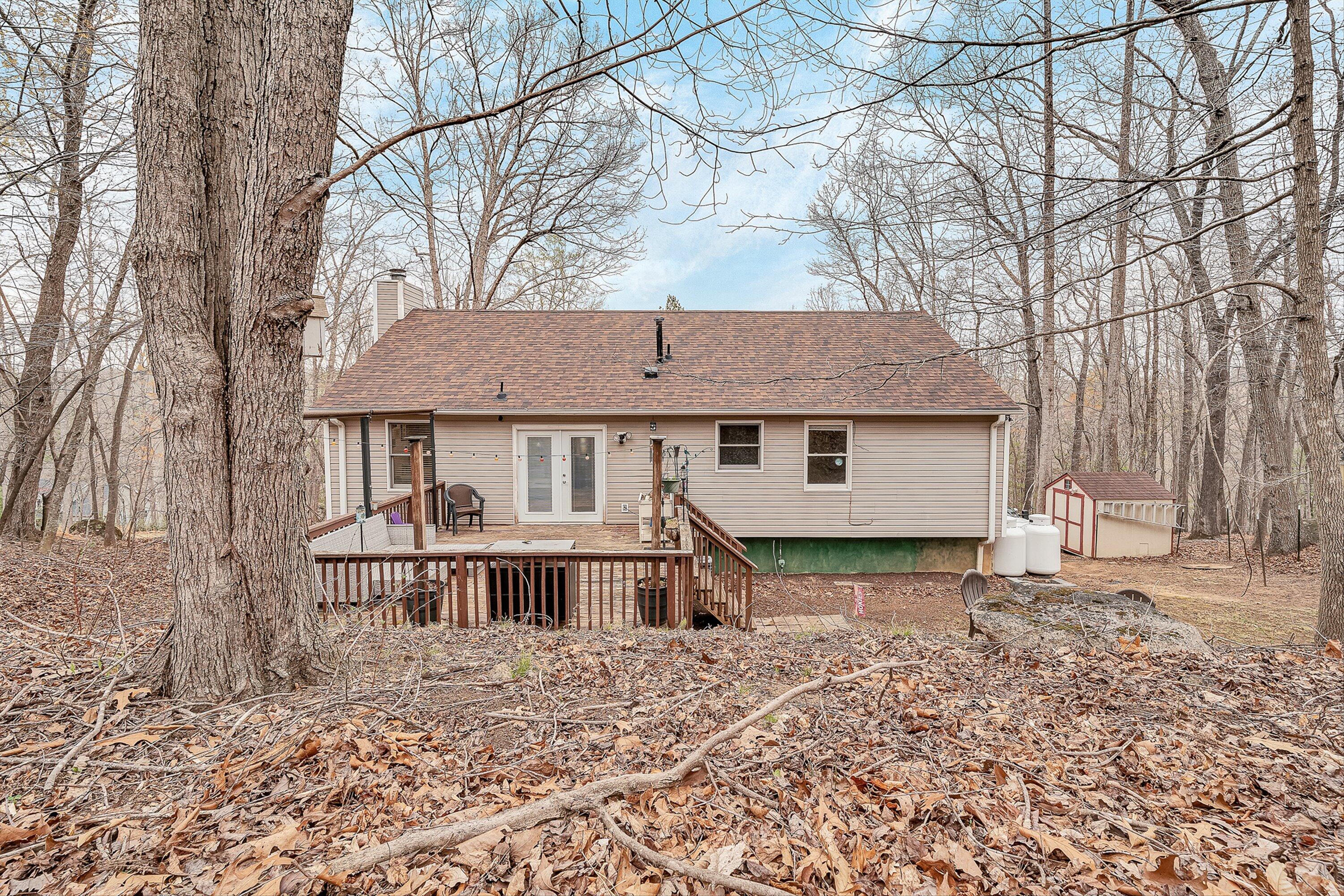 769 Lakeshore Terrace Road Hardy, VA 24101 - Photo 34 of 38 a view of a house with a yard and large trees