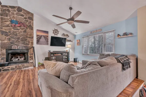 a living room with furniture a fireplace and a flat screen tv