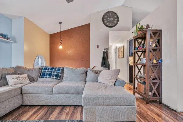 a living room with furniture and a wall painting
