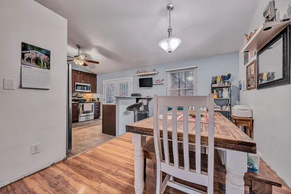 a living room with stainless steel appliances kitchen island granite countertop furniture and a kitchen view