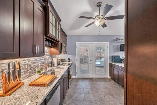 a kitchen with stainless steel appliances granite countertop a refrigerator and a sink