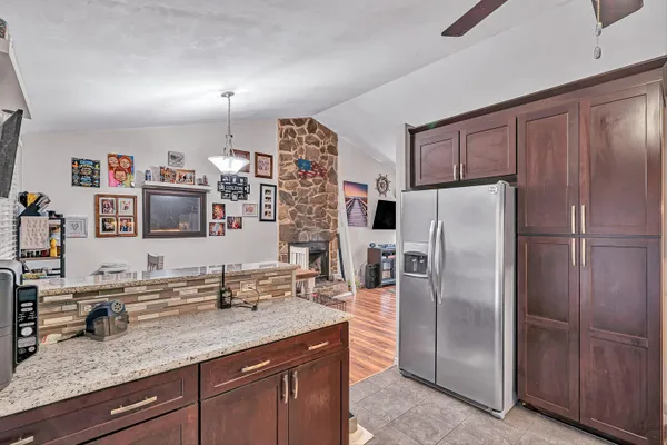 a kitchen with stainless steel appliances granite countertop a refrigerator and a sink