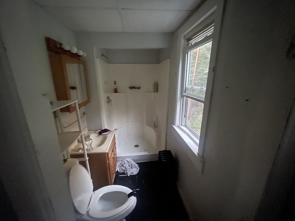 22 Taunton Street Worcester, MA 01604 - Photo 4 of 6 a bathroom with a toilet mirror vanity and window