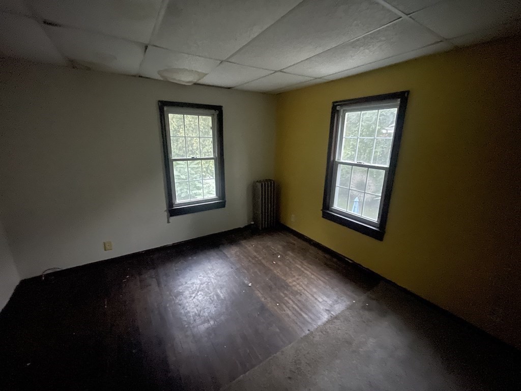 22 Taunton Street Worcester, MA 01604 - Photo 5 of 6 a view of an empty room with wooden floor and a window