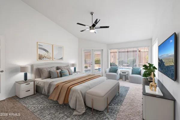 a spacious bedroom with a bed a couch and a flat screen tv