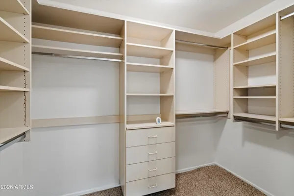 a view of walk in closet with empty racks