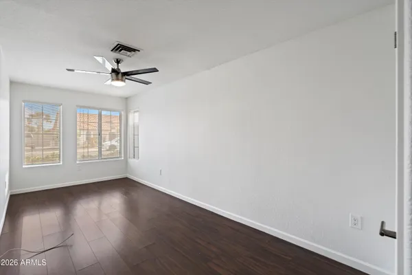 a view of wooden floor and windows in a room
