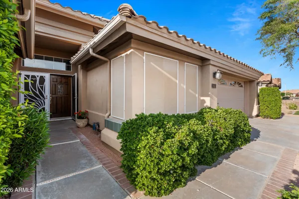 a front view of a house with garden