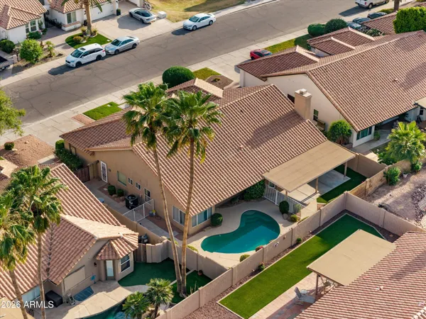 an aerial view of a house with a yard