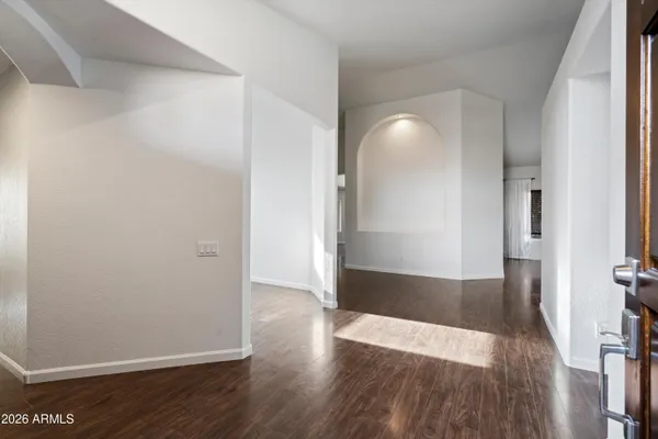wooden floor in a hall with an empty room