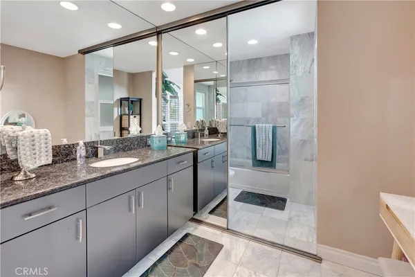 a bathroom with a sink double vanity and a shower