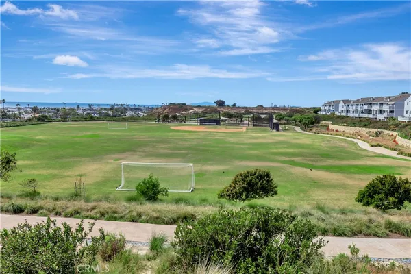 a view of a field with an ocean