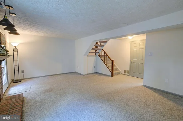 a view of an empty room with stairs
