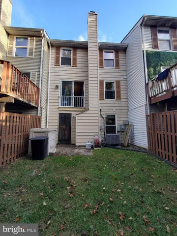 a view of a house with a yard and a car parked in front of it