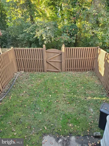 a view of a backyard with fence