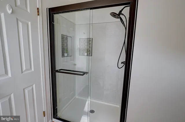 a bathroom with a glass shower door