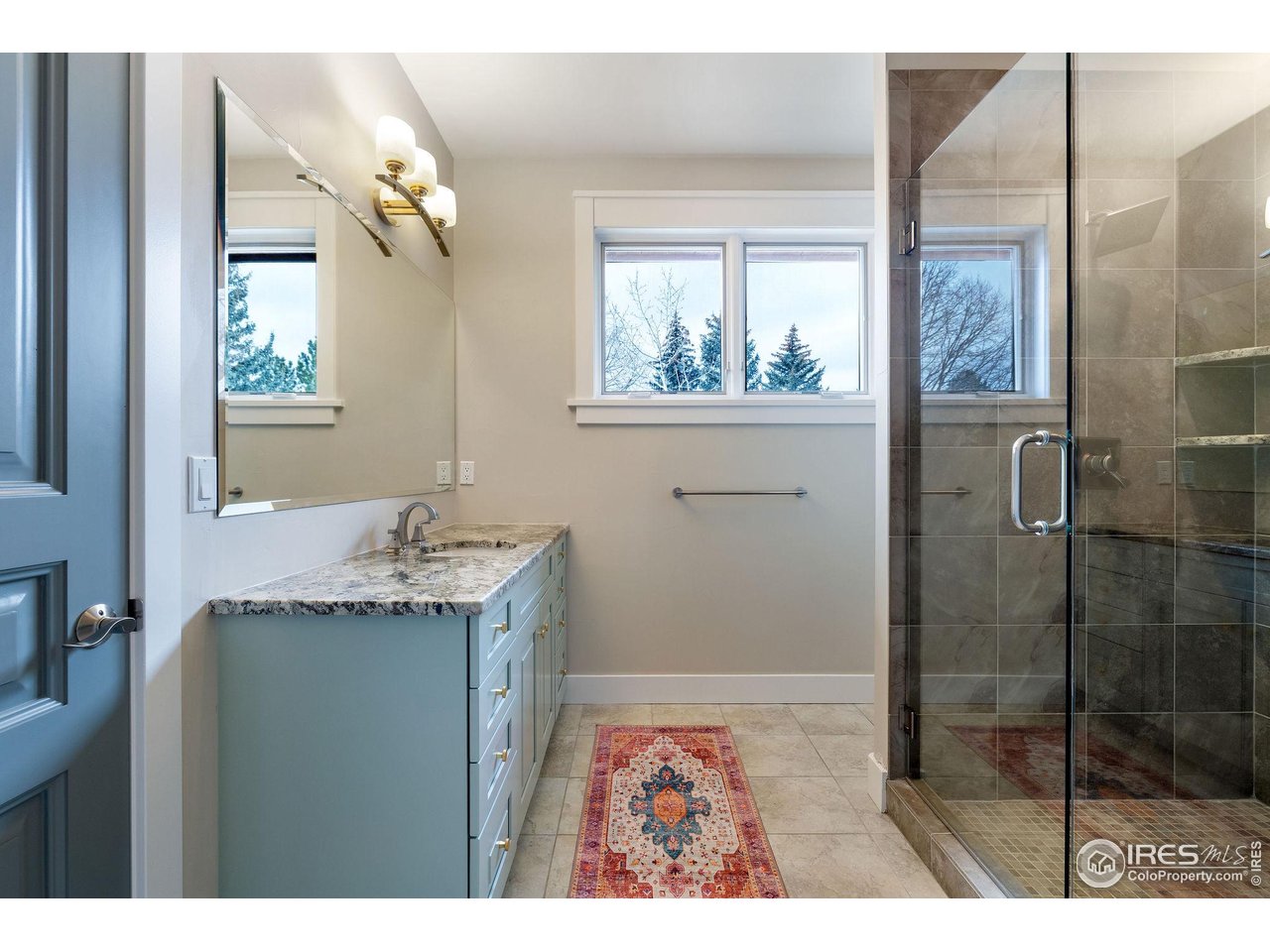 7205 Rustic Trail Boulder, CO 80301 - Photo 34 of 49 a bathroom with a granite countertop sink a mirror and shower
