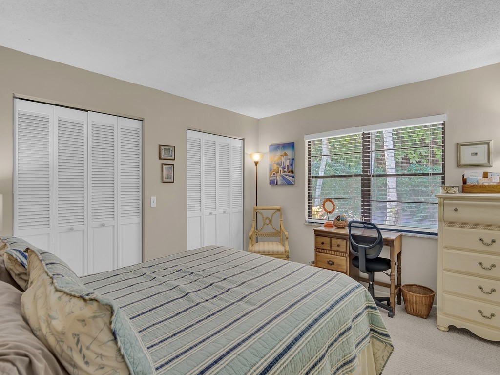 1045 Clipper Road Vero Beach, FL 32963 - Photo 19 of 36 a bedroom with a bed and a window