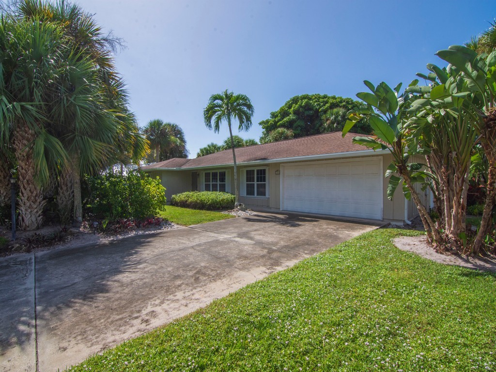 1045 Clipper Road Vero Beach, FL 32963 - Photo 21 of 36 a front view of a house with a yard and potted plants