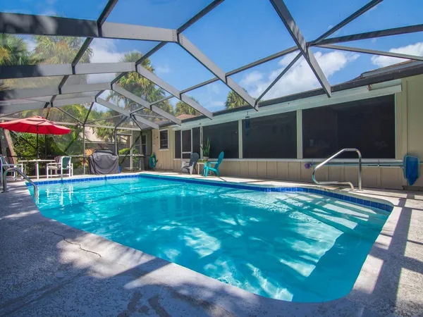 a view of a backyard with table and chairs