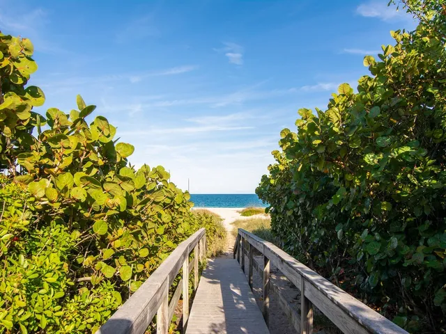 a view of balcony with wooden floor and fence