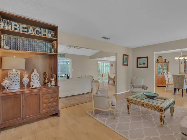 a living room with furniture a rug and a painting on the wall