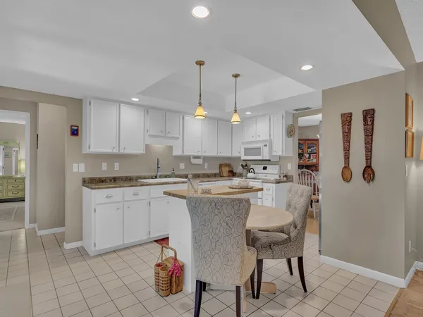 a kitchen with stainless steel appliances kitchen island granite countertop a sink and cabinets