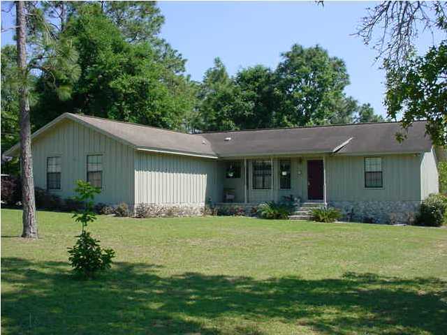 252 Ridge Lake Road Crestview, FL 32536 - Photo 2 of 4 a front view of a house with a yard and garage