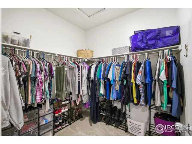a view of walk in closet with clothes