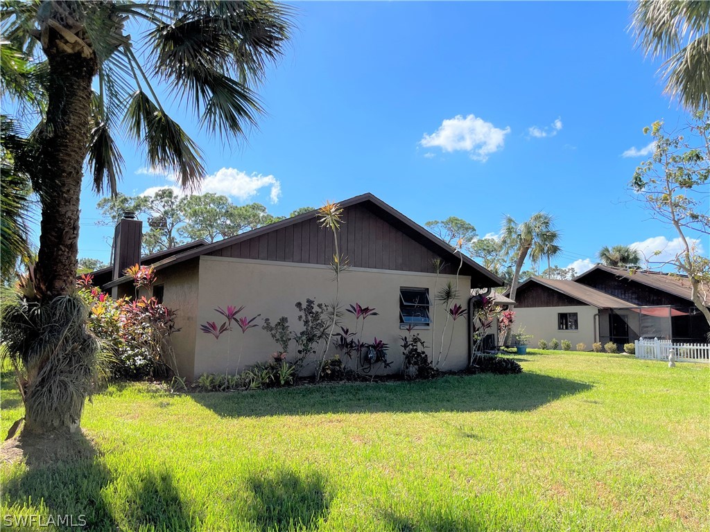 5650 Park Road Fort Myers, FL 33908 - Photo 11 of 15 a view of a house with swimming pool lawn chairs and a yard