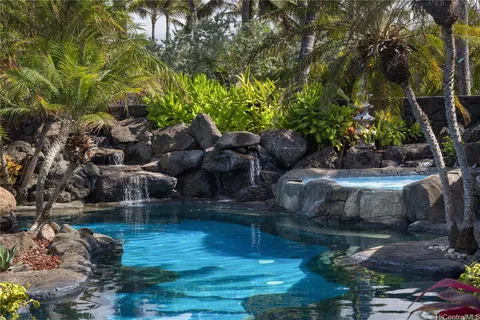 a view of swimming pool with seating area and hardwood vanity